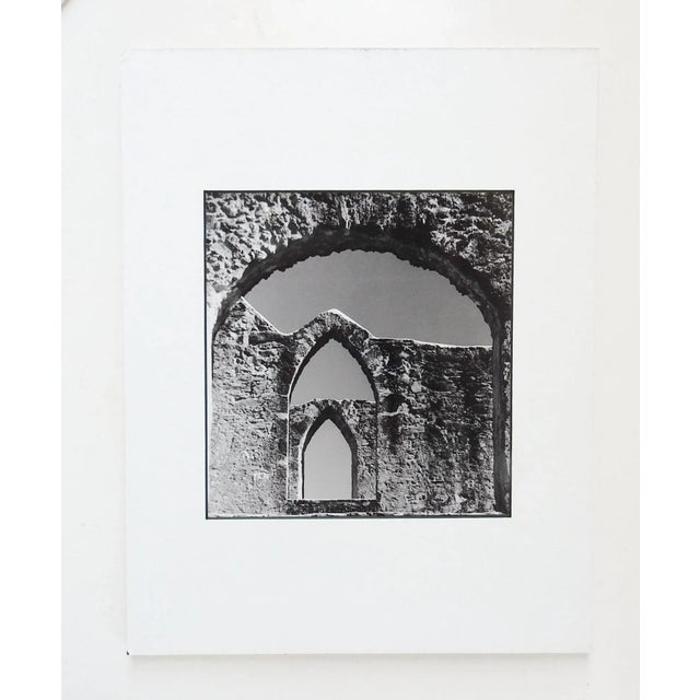 Vintage black and white photograph on paper of church ruins. Unsigned. Unframed, displayed in mat and backing, opening is...