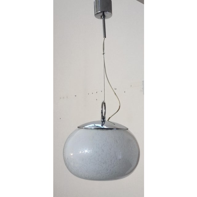 Magnificent pendant lamp by Mazzega. Italy, 1970s. Chrome-plated metal frame. It supports a large Murano blown glass...