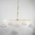 Modern linear bras chandelier with ovoid spotted Murano glass shades
