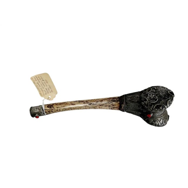 A striking Tibetan ritual trumpet, traditionally known as a kangling, crafted from a human femur bone and adorned with low...