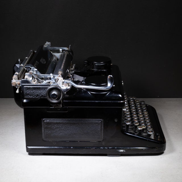 ABOUT An Art Deco Royal KHM series standard typewriter with black high gloss finish and gull wings. The nickel keys are...