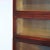 An antique Arts and Crafts barrister bookcase offers mahogany raised panel construction with four stacks having pull out...