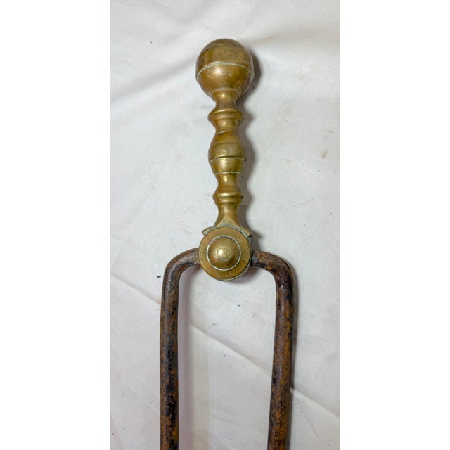 Up for sale is a pair of rare antique 18th century wrought iron and brass English fireplace tongs. The arms are wrought by...