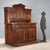 Baroque double-body walnut sideboard. The three-door cabinet features a taller central door with a curved moulding, a...