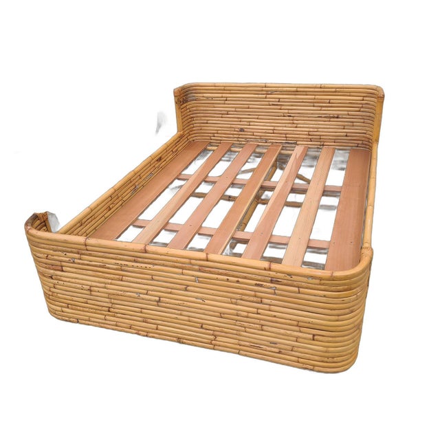 This full-sized bed frame was built by Seven Seas Rattan Company (1938 to 2011) in the 1950s. It features a stacked rattan...