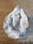 This large quartz crystal geode specimen features an open cavity filled with sparkling white and translucent crystal...
