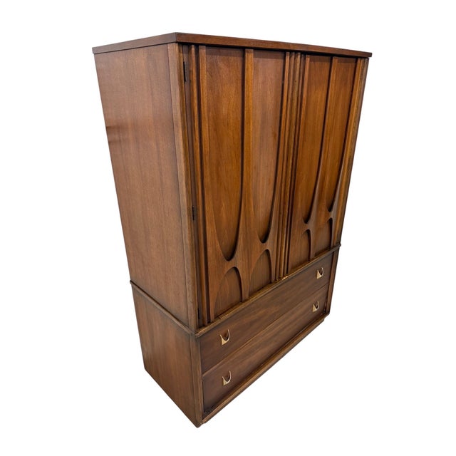 An iconic piece from one of America’s most celebrated furniture lines, this vintage Broyhill Brasilia II walnut armoire...