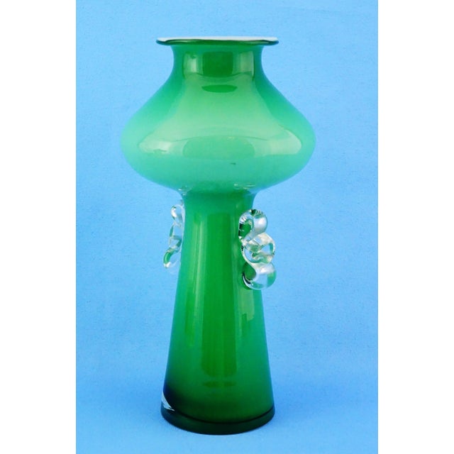 MEASUREMENTS: Height: 30 cm; Diameter: 15 cm; Weight: 1.137 kg Item : Impressive vase made of green cased glass with an...