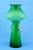 MEASUREMENTS: Height: 30 cm; Diameter: 15 cm; Weight: 1.137 kg Item : Impressive vase made of green cased glass with an...
