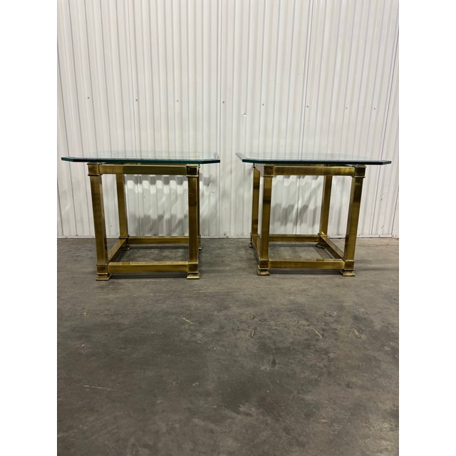 Beautiful 1970's glass and brass end/side tables by Mastercraft. Brass frame with thick beveled glass top. Clean lined and...