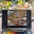 This oil on panel artwork captures a serene stream bed, where smooth stones and flowing water intertwine in a vibrant...