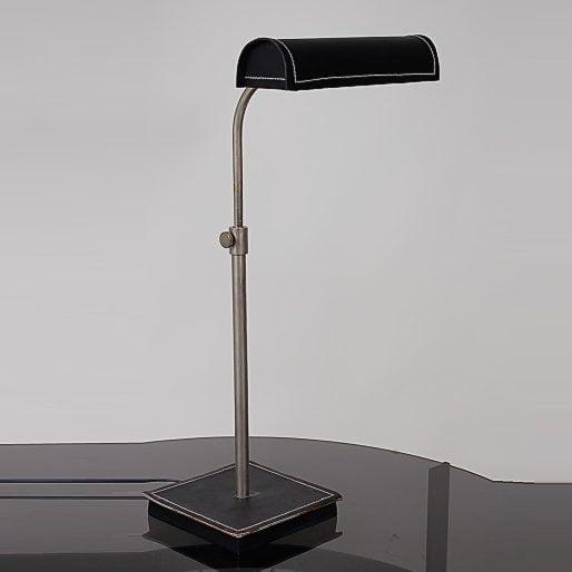 This chrome plated metal table lamp has a unique design that reminds of the style of Jacques Adnet, manufactured in France...