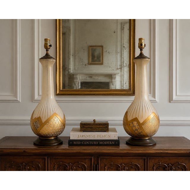 A striking pair of vintage Mid-Century Modern table lamps attributed to Fortune Lamp Co., showcasing elegant bottle-form...