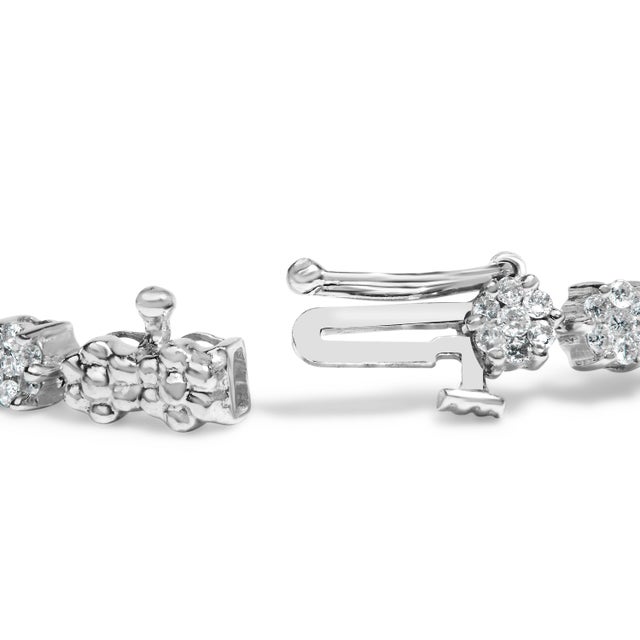 Embrace timeless elegance and enduring luxury with this exquisite 14K white gold diamond link bracelet, where...
