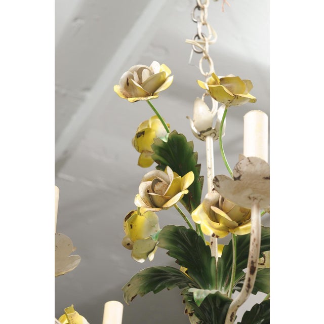 A charming Italian tole chandelier adorning hand-painted yellow roses. Six scrolling arms emerge from a tied bouquet base,...