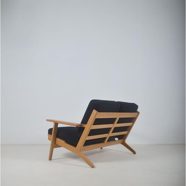 Danish sofa GE-290 designed by Hans Wegner in 1953. This high-quality two-seater was made by Getama. The beautifully...