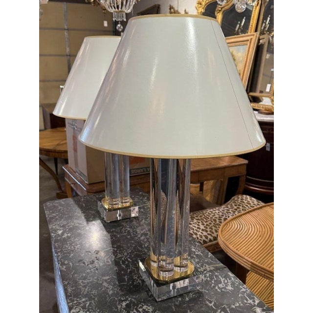 Beautiful pair of Karl Springer Mid-Century Modern lucite and brass lamps. Elegant and timeless for a fine home. Circa...