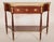 Louis XVI style mahogany console desserte with marble top, circa 1930. The top with inset marble and a reticulated brass...