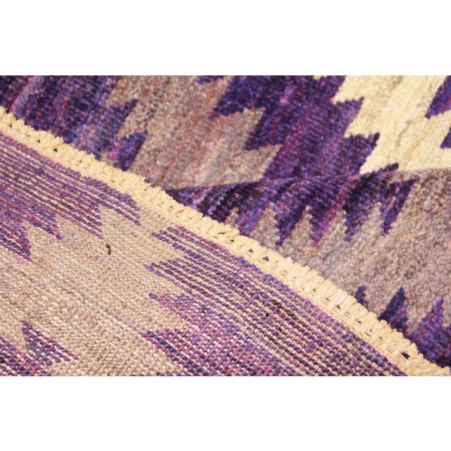 Its a brand new handmade rug with hot organic purple colors and ivory .