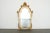 Elegant vintage La Barge wall mirror featuring an ornate giltwood frame with beautifully detailed scrolling foliage and...