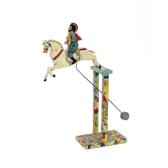 Unique handmade folk art kinetic balancing sculpture of a soldier riding a horse. The soldier is dressed in Roman or...