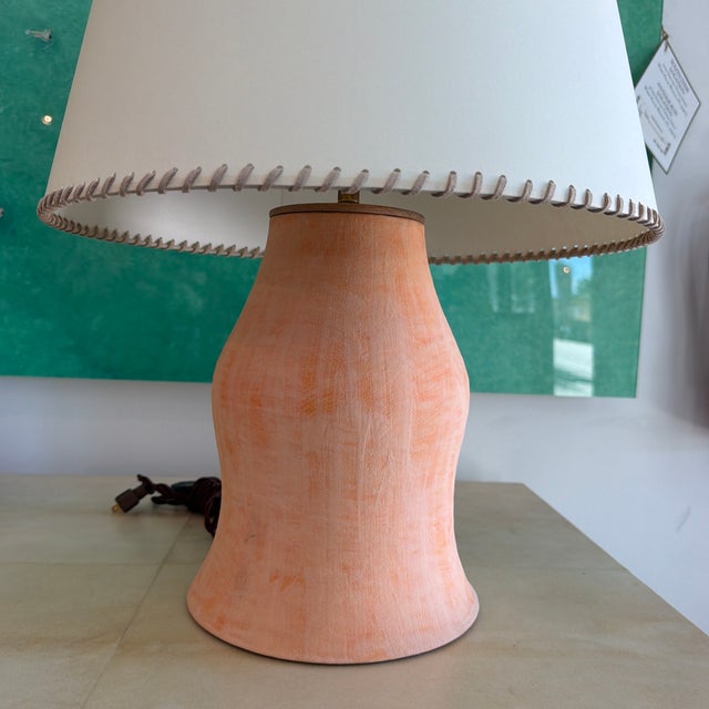 Glazed ceramic earthenware table lamp with coral curving form. Mounted with wood cap and wired with unlacquered brass...