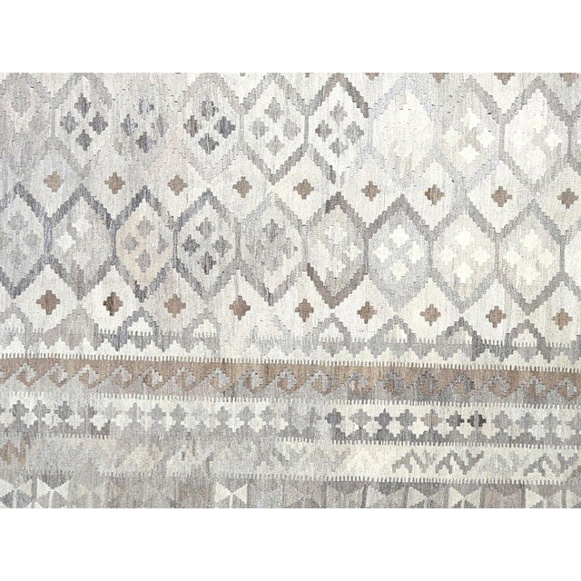 Hand-woven wool kilim from the Maimana tribes of Northern Afghanistan, featuring the characteristic flat-weave...