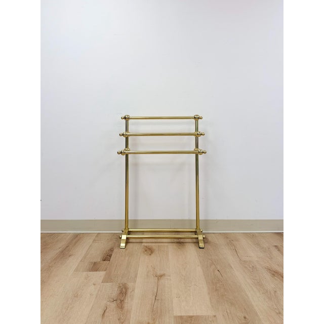 This elegant vintage polished brass three-tier freestanding towel rack is a refined and practical bathroom or bedroom...