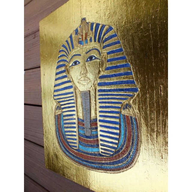 Gorgeous handcrafted relief of the golden death mask of the pharaoh tutankhamun and hieroglyphs names , exquisite ancient...