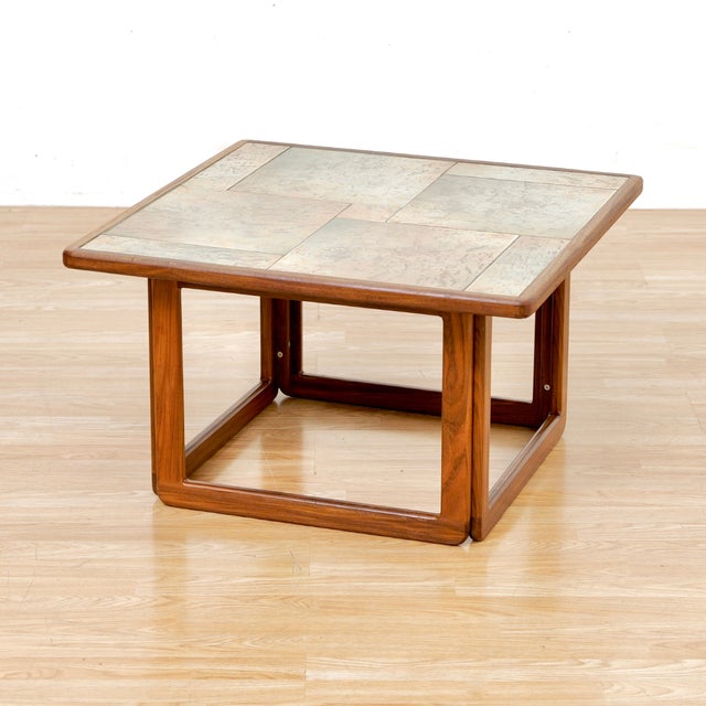 This teak and tile top coffee table was made in Denmark during the 1970s. With beautiful earth toned tiles that sit in a...