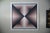 Soft blush, dusty rose, and deep charcoal pull you straight into the center of this 1980 Op Art screenprint by German...