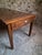 An antique French farmhouse dining table dating from around 1850–1900. The table has a solid oak base with a pine top and...