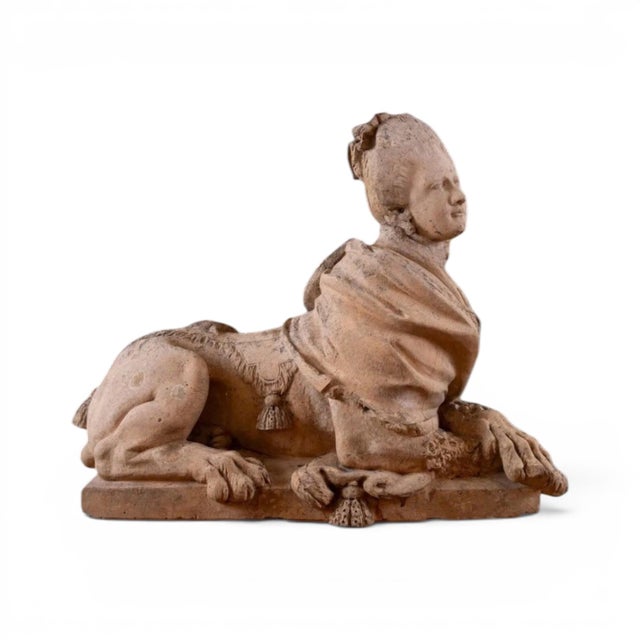 A striking 18th century European pair of terracotta sphinxes, modeled in a classical tradition that blends mythological...