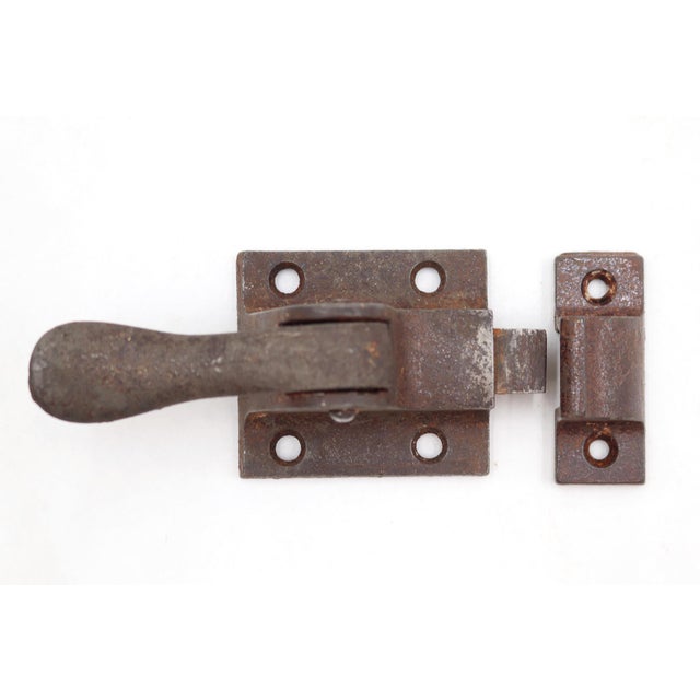 Antique transom window latch made of cast iron with a spring loaded lever. The original mounting screws are not available....