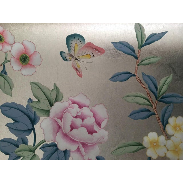 Elegant hand painted silver foil wallpaper sample featuring delicate flowers, botanical branches, and a graceful butterfly...
