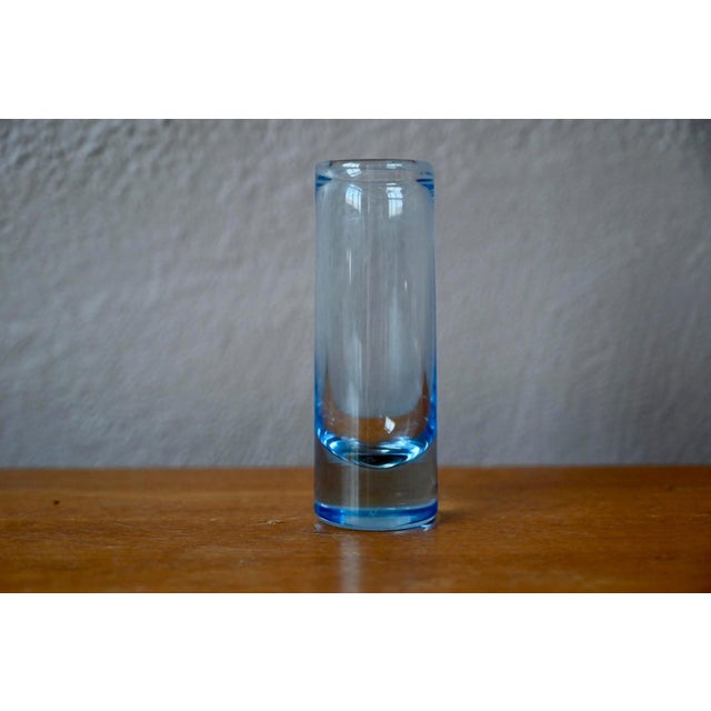 This bluish glass bud vase is a Swedish artistic piece, likely by Holmegaard, dating from the 1950s. Crafted with soft,...