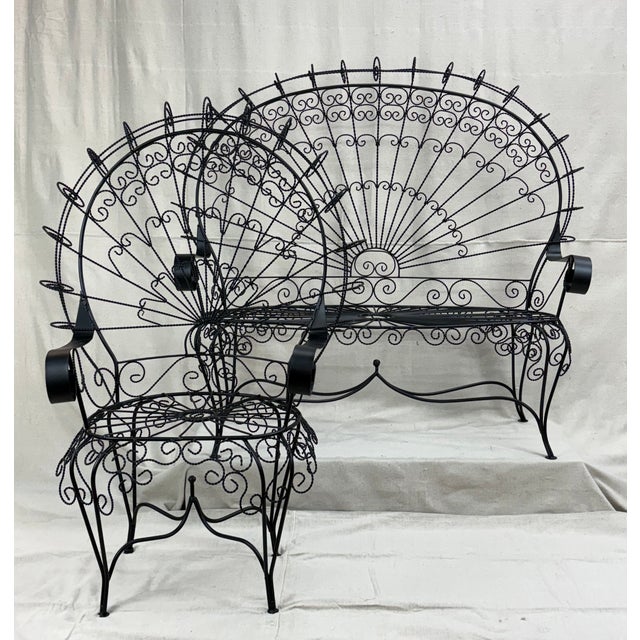 A sculptural midcentury seating pair by John Salterini, celebrated for his lyrical wrought iron designs. This bench and...