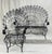 A sculptural midcentury seating pair by John Salterini, celebrated for his lyrical wrought iron designs. This bench and...