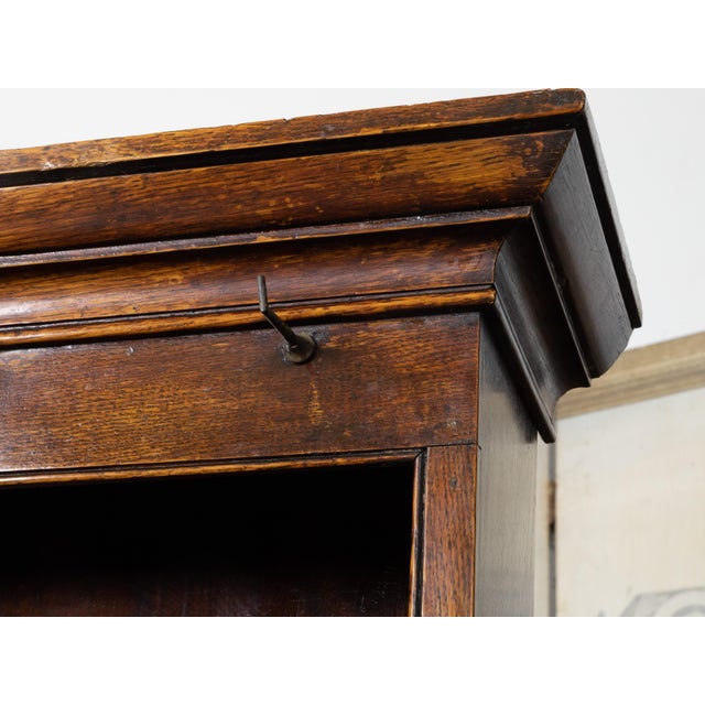 An English oak Welsh dresser from the 19th century, with open shelves, petite hooks and low sideboard with two doors,...