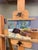 This oil on panel artwork captures a serene moment of intimacy, featuring a figure reclining in a softly lit interior. The...