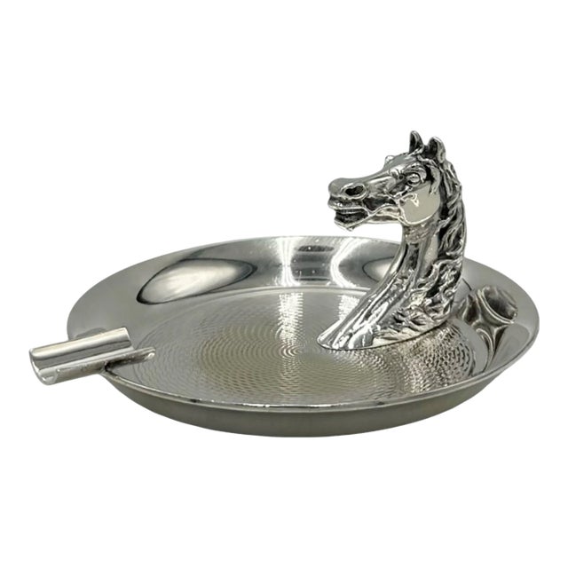 A handsome vintage Hermès Paris silverplate ashtray featuring a sculptural horse head in profile—an enduring symbol of the...