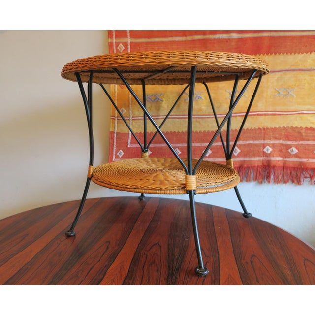 Finely made bamboo / rattan and iron two-level coffee table dating from the 1960s.