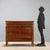 Directoire chest of drawers made of walnut, dating back to the early 19th century in Italy. The structure features a front...