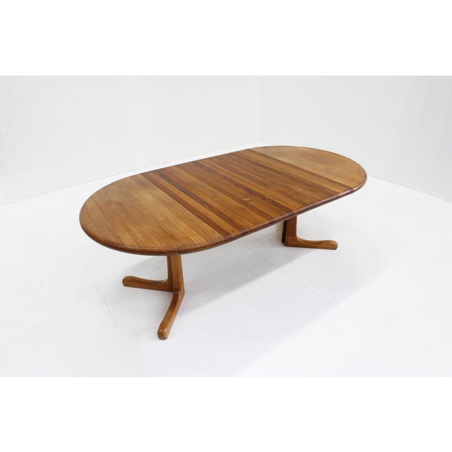 Vintage Danish round extendable dining table from the 1960s made of solid teak wood. This Danish dining table can be...
