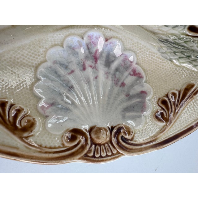 Made by Faiencerie d'Onnaing. This plate features high relief barbotine molding of bundled asparagus stalks with green and...