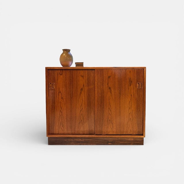 Compact mid-century cabinet with striking wood grain and clean architectural lines elegant danish sideboard attributed to...