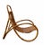 An elegant rattan armchair with a curved bamboo cane frame and a hand-woven cane seat, creating a natural and relaxed...