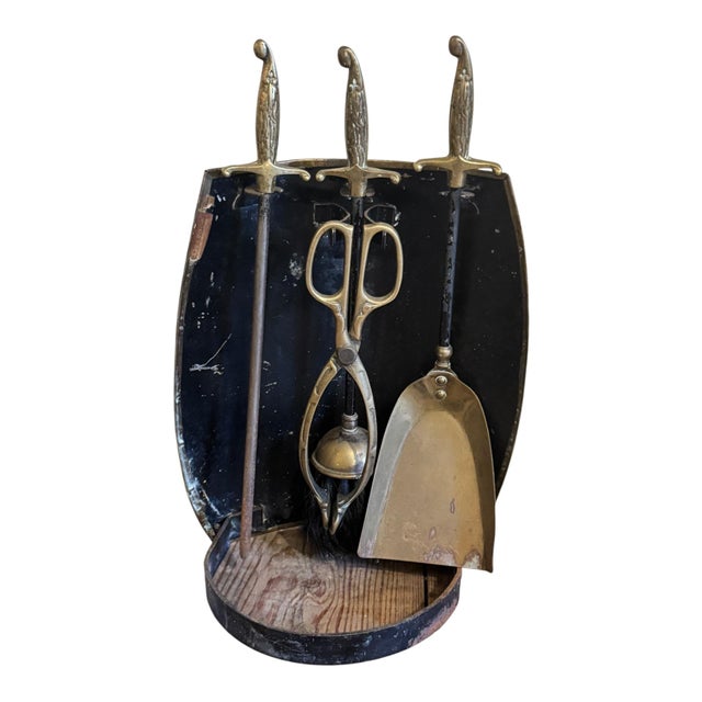 A wonderfully characterful antique brass fireside companion set by Peerage, England, dating to the early 20th century. The...