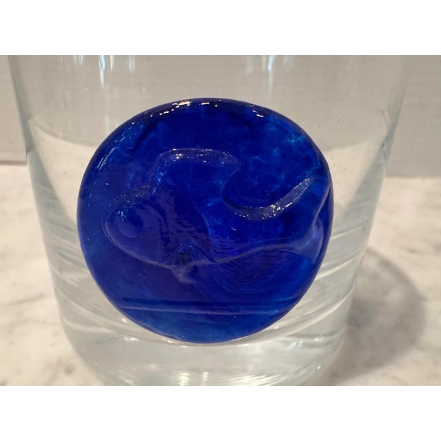 A very unique set of eleven lowball tumblers in clear glass with applied cobalt blue glass fish medallions. Excellent...