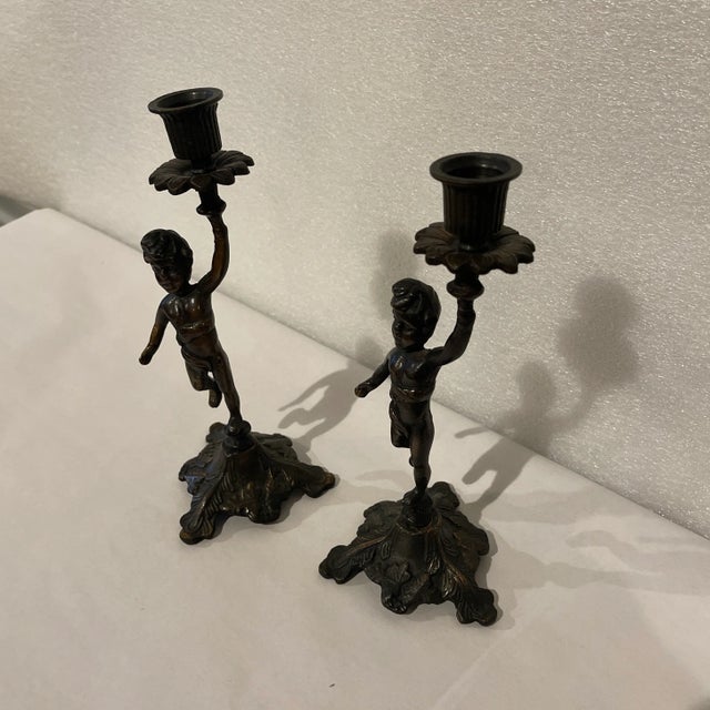 Beautiful pair of solid bronze Austrian cherub candle stick holders in the rococo Louis XV style. Faces with embossed...